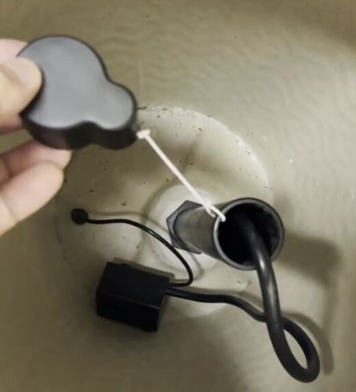 Close-up photograph of the cover being placed onto the tube inside the fountain base.